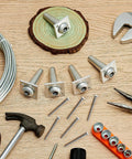 Five Piece Anchor Wire Vise Set for Tightening 12 to 13 Gauge Wire on wooden surface with tools and wire