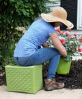 Person gardening using the green Built Tough 3 Level Work And Garden Seat With Flip Heights at 9, 12 and 15 Inches, One Piece Weatherproof Construction.