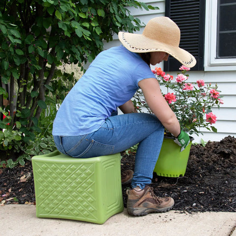 Person gardening using the green Built Tough 3 Level Work And Garden Seat With Flip Heights at 9, 12 and 15 Inches, One Piece Weatherproof Construction.