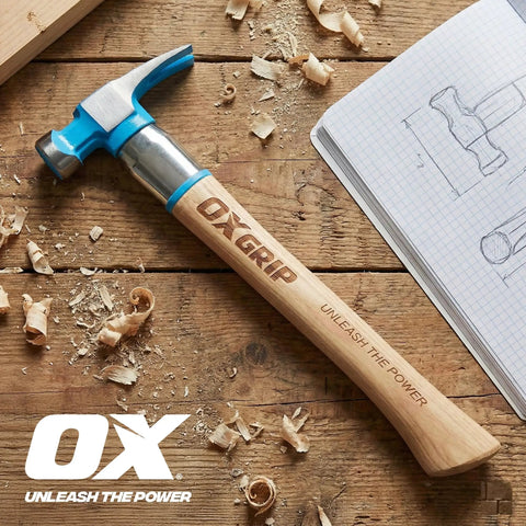 Framing Hammer 22 Oz With Milled Face And Curved Hickory Wood Handle, Steel Overstrike Protection on wooden table with shavings