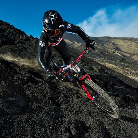 Cyclist with Full On Mountain Bike Handlebar, 31.8mm Clamp, 785mm Wide, 30mm Rise Beefy Alloy Riser Bar on rugged trail