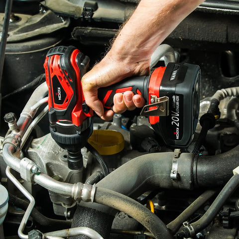 Hand using Beefy 20V Cordless Impact Wrench Kit With 300 Ft Lb Torque Half Inch Detent Anvil 2700 IPM 2200 RPM Belt Clip in engine bay