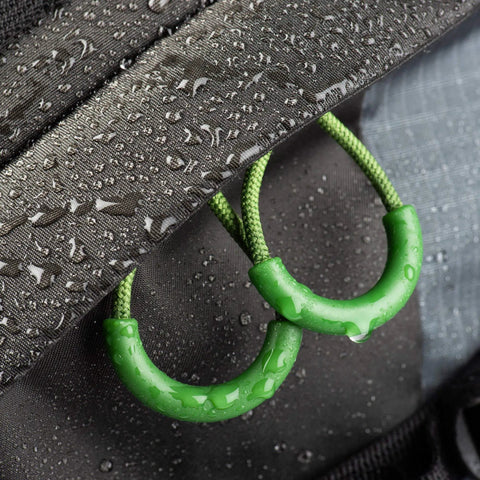 Close-up of Rotating 50L Plus Camera Backpack weatherproof zippers with DWR-coated fabric for adventure photography.