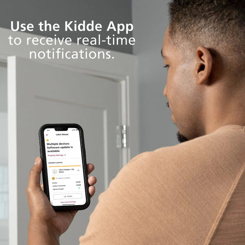 Person using Kidde app on phone to receive real-time notifications for WiFi Water Leak Detector and Freeze Alarm with Alexa Compatibility