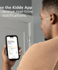 Person using Kidde app for real-time alerts on 4 Pack WiFi Water Leak Detector And Freeze Alarm For Home, Alexa Compatible.