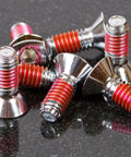 Close-up of fasteners coated with VC-3 Threadmate Red Threadlocker And Tape Kit For Fasteners, Instant Lock And Seals.