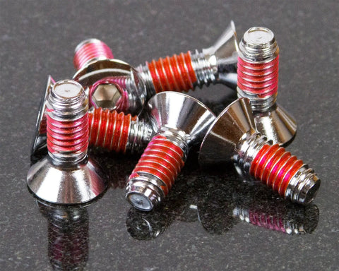 Close-up of fasteners coated with VC-3 Threadmate Red Threadlocker And Tape Kit For Fasteners, Instant Lock And Seals.