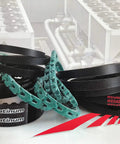 Assorted industrial drive belts with focus on Cogged Raw Edge V Belt AX22 24 Inch Outside Length One Half Inch Top Width Eleven Thirty Second Inch Thick Pack Of One Tough Power Transmission Belt For Heavy Duty Machinery And Industrial Drives.