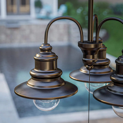 Close-up of Broadcast 3 Light Outdoor Chandelier In Oil Rubbed Bronze With Copper Highlight Finish, poolside view