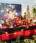 Iron Classic Red 12 Inch Pickup Truck Figurine For Home Decor amidst Christmas lights and ornaments on a festive table.