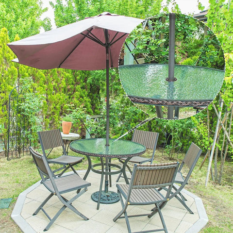 Patio table with 2 Inch Patio Table Umbrella Hole Ring Cap Set For 1.65 Inch Poles in garden setting, protecting tabletop.