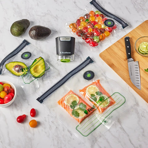 Reusable Quart Vacuum Zipper Bags, 10 Count, BPA Free, Microwave Safe, with assorted foods on a kitchen counter