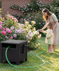 Mother and child using Resin Garden Hose Reel Hideaway With Easy One Hand Rewind Outdoor Hose Storage Cabinet in garden