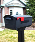 Patriot Large Capacity Rust Proof Plastic Post Mount Mailbox in Black with wide opening in front of a house