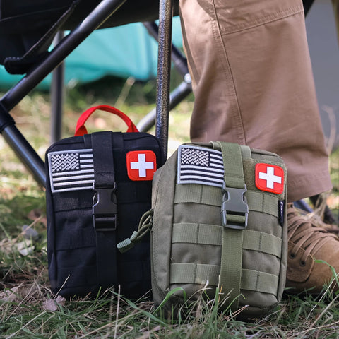 Front view of two compact tactical trauma pouches (black and olive) with US flag and red cross patches.