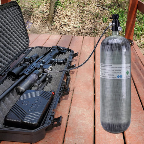 Paintball fill station valve attached to a 4500 psi scuba tank with 20-inch hose beside a marker in a foam case.