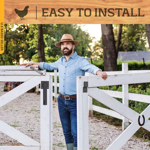 Person standing beside a white wooden gate secured with Black Barn Door Latch Hook With Hardware Reversible Privacy Lock.