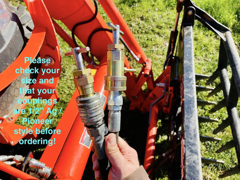 Hand holding hydraulic quick coupling pressure relief tool for half inch Pioneer ag poppet style fittings on tractor