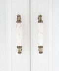 Solid As A Rock Cabinet Door Pulls Set Of Four Marble Ceramic Handles Heavy Duty Zinc Base Anti Rust Finish Easy No Sweat Install 3.78 Inch Center Spacing For Kitchen Hardware close-up of two bronze handles on white cabinet.