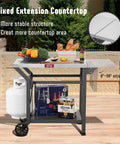 Movable Grill Table With Folding Side Table And Pizza Oven Prep Cart For Outdoor And Indoor Use, Stainless Steel 43 Inch Tabletop With Undershelf, Six Utensil Hooks, Gas Cylinder Hook, Easy Foldable Extension, Grey, front view with food items and gas cylinder.