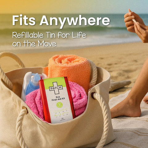 Patch Eco First Aid Kit tin in red with green label inside a beige tote bag on the beach