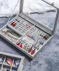 Open jewelry box showcasing earrings, necklaces and rings with "Brass Corner Protectors For Jewelry Boxes And Woodworking Projects Antique Style Box Corner Guards Built Tough With Lightweight Golden Finish Safe Delicate Look Perfect For Furniture Corners And Crafting" on a soft gray background.