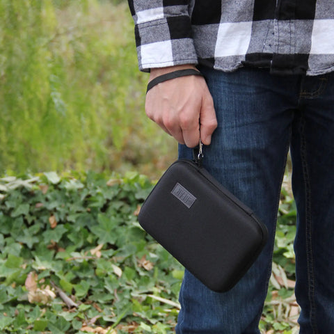 USA Gear Laser Measurement Tool Hard Case held by a person, showcasing the durable black hard shell with wrist strap.