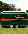 Side view of a green turnkey mobile food truck and portable snack cart with 'Grill Master' branding for street food business.
