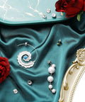 Jumbo Earring Backs For Heavy Studs And Droopy Posts Replacement Secure Lifters 9mm Silver 8 Pack on teal fabric with roses