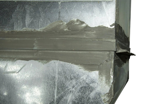 DS-530 Duct Seal 5 Lb Gray Indoor Sealant Putty applied on metal conduit opening, sealing against dust and moisture.