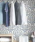 Guildford Peel And Stick Damask Wallpaper Blue, 20.5 Inch by 18 Foot Roll in closet with hanging clothes