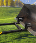60 Inch Clamp On Pallet Forks For Tractor Bucket Built Tough With 2000lbs Capacity, shown attached to a bucket on grassy field.