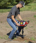 Man operating Earth Auger Combo With 52cc Two Cycle Powerhead And 8 Inch Auger Included Heavy Duty Handlebars Model 58630 in field