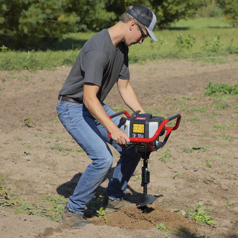 Man operating Earth Auger Combo With 52cc Two Cycle Powerhead And 8 Inch Auger Included Heavy Duty Handlebars Model 58630 in field