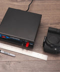 Powerful Bench Power Supply For Home Lab 30 Amp Regulated AC To DC Converter with camera and ruler on wood surface