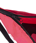 Close-up of red hand operated bag spreader seeder for lawn and garden with high RPM gearbox, featuring zippered top.