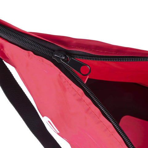 Close-up of red hand operated bag spreader seeder for lawn and garden with high RPM gearbox, featuring zippered top.