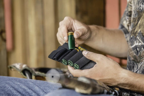 Hand holding Grab And Go Butt Stock Shotgun Shell Holder For Quick Access Black Holds Five Shells Secure Wrap Around Design
