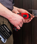 Person using Cordless Electric Screwdriver Kit with Built In LED Light and 31 Pc Bit Set on door hinge.