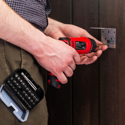 Person using Cordless Electric Screwdriver Kit with Built In LED Light and 31 Pc Bit Set on door hinge.