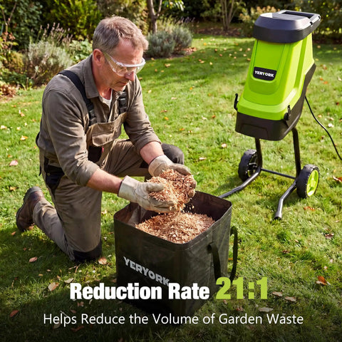 Man operating Electric Wood Chipper And Shredder With 15 Amp Motor, 1.8 Inch Cutting Capacity, 45 Liter Collection Bag in garden