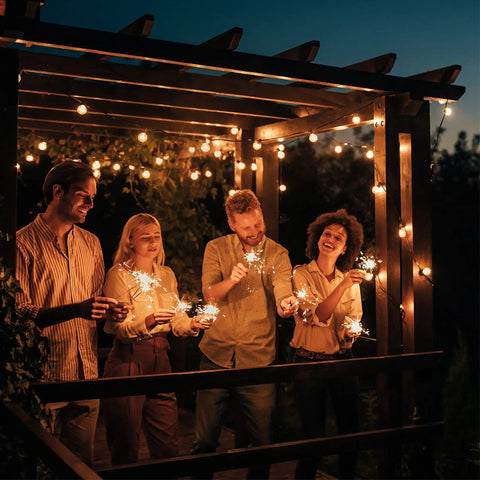 People enjoying backyard ambiance under 48Ft 15-Socket LED Outdoor String Lights With Remote Control Alexa Compatible And Smart Life App