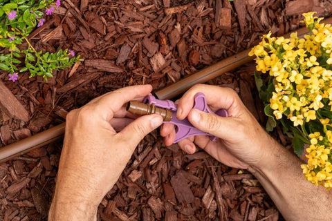 Hands using Drip Irrigation Barbed Fitting Insertion Tool For One Half Inch Tubing, Easy Full Insertion And Secure Locking