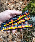 Hand holding fire rope tinder from Ferro Rod Fire Starter Kit With A Large One Half Inch Rod, Fire Tinder And Custom Carry Pouch.