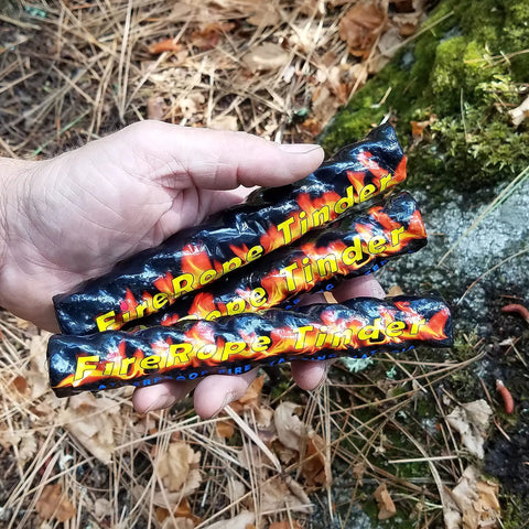 Hand holding fire rope tinder from Ferro Rod Fire Starter Kit With A Large One Half Inch Rod, Fire Tinder And Custom Carry Pouch.