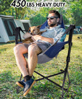 Man relaxing with dog in Hammock Camping Chair With 3 Height Settings And Headrest Portable Adjustable Backrest outdoors.