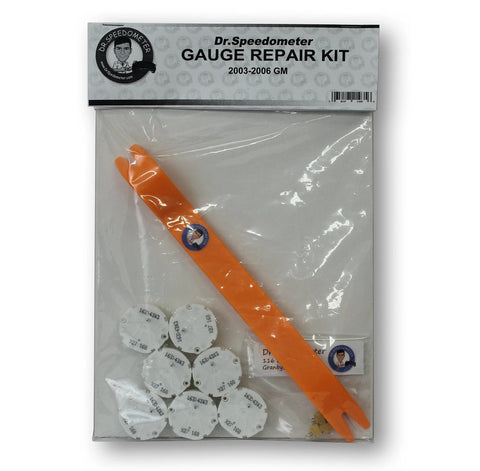 Dr.Speedometer GM gauge repair kit front view: orange plastic pry tool and white circular gauge motor discs in bag