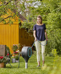 Woman using Automatic Retractable Garden Hose Reel With 50 Feet Of Easy Retracting Hose 360 Degree Swivel Metal Spike Base in garden