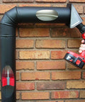SootEater Pellet Stove Cleaning Kit with Flexible Rods Rotary Vent Kit used on black stove pipe with drill attachment.