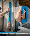 Using Pro Grade 2 Foot Aluminum Level Box Beam With Magnified Vials held against brick wall illustrating grip handle